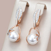 Earrings with pearl pendant and white zirconia leaves in 18K rose gold plating