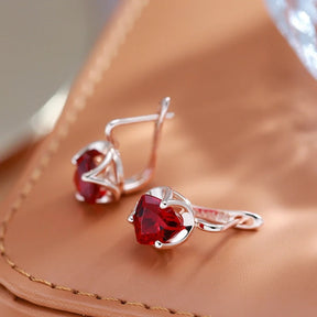 Stud earrings with ruby zirconia in 18K rose gold plating